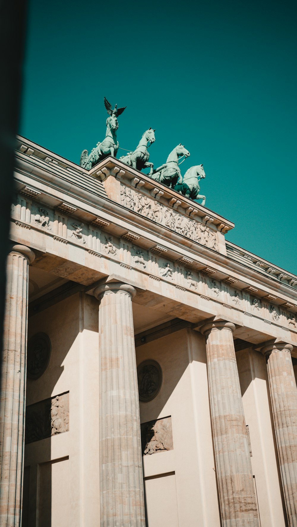 a tall building with statues on top of it