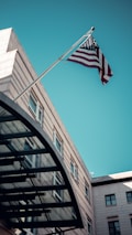 an american flag flying in front of a building