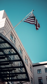 an american flag flying in front of a building