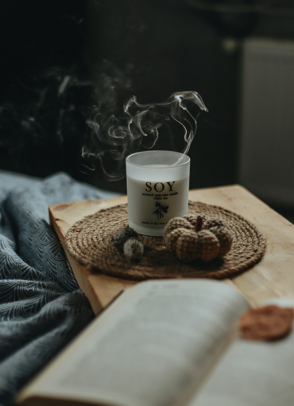 a cup of coffee on a tray with a book