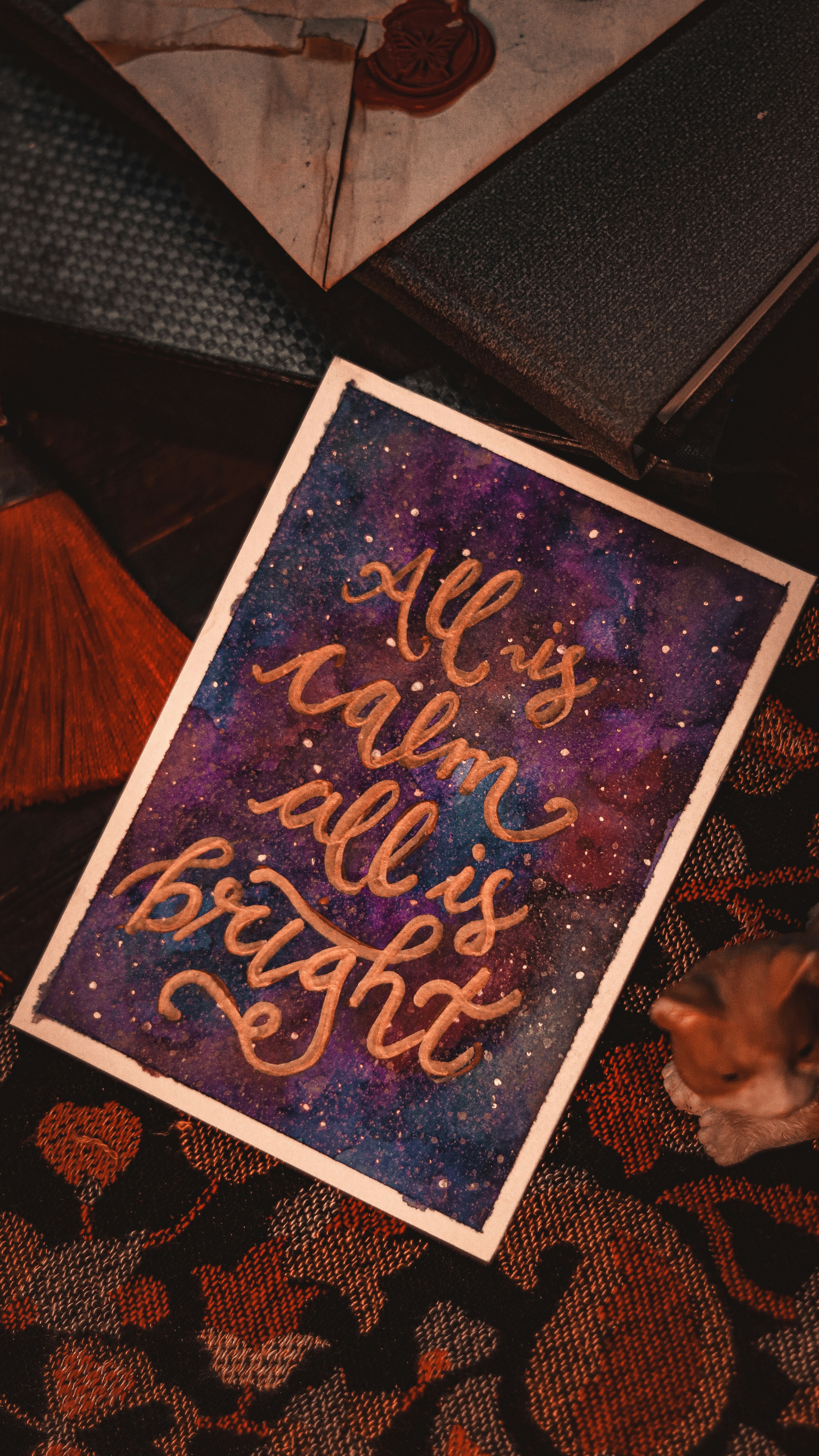 a picture of a cat sitting next to a sign