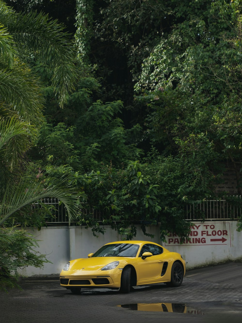 a yellow sports car parked in a parking lot