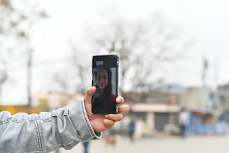 a person taking a picture with a cell phone