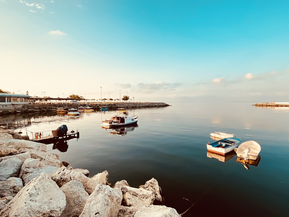 a group of boats floating on top of a body of water