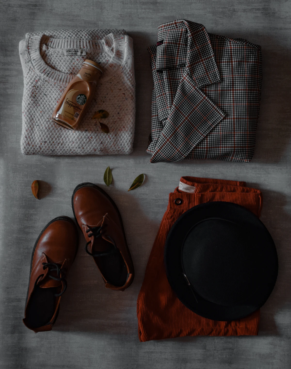 autumn outfit laid out with knit, hat and leather shoes