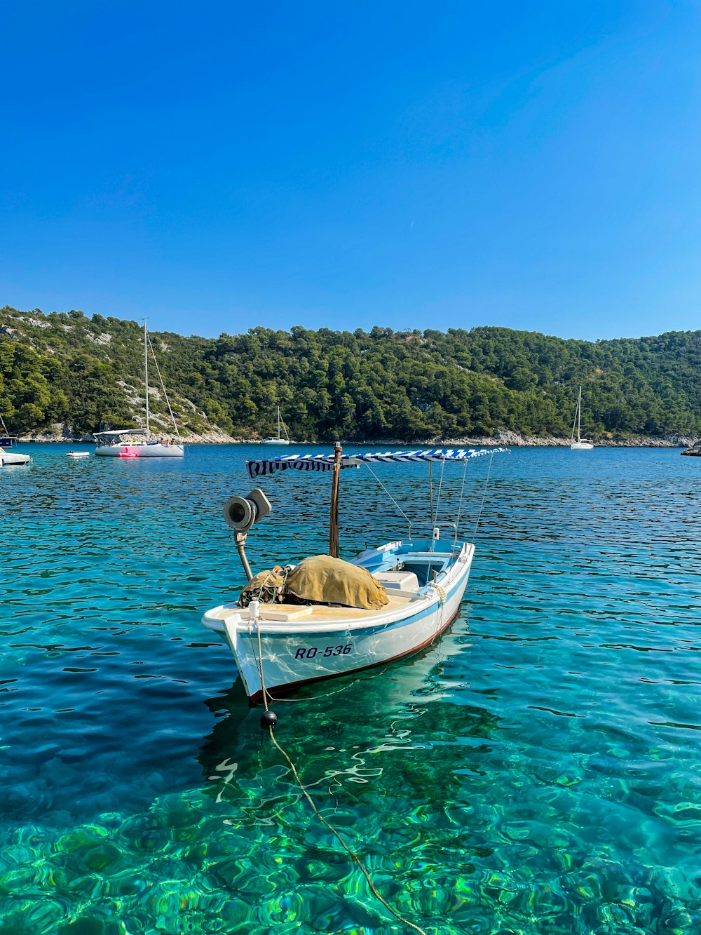 a small boat floating on top of a body of water