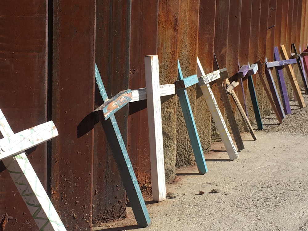 a row of crosses sitting on the side of a road