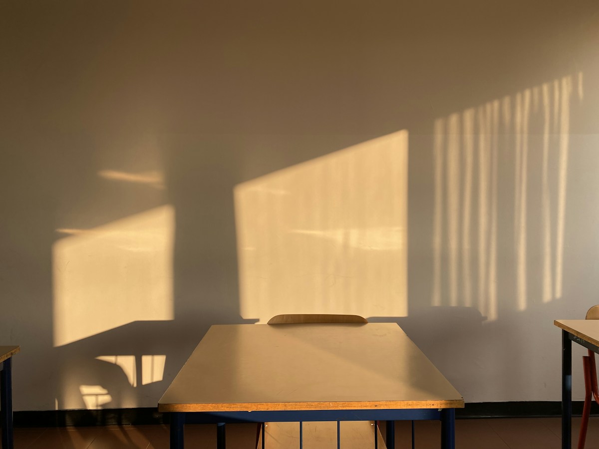 A sunlit classroom with a table and chairs, ideal for teaching Bible memory verses for Sunday School.