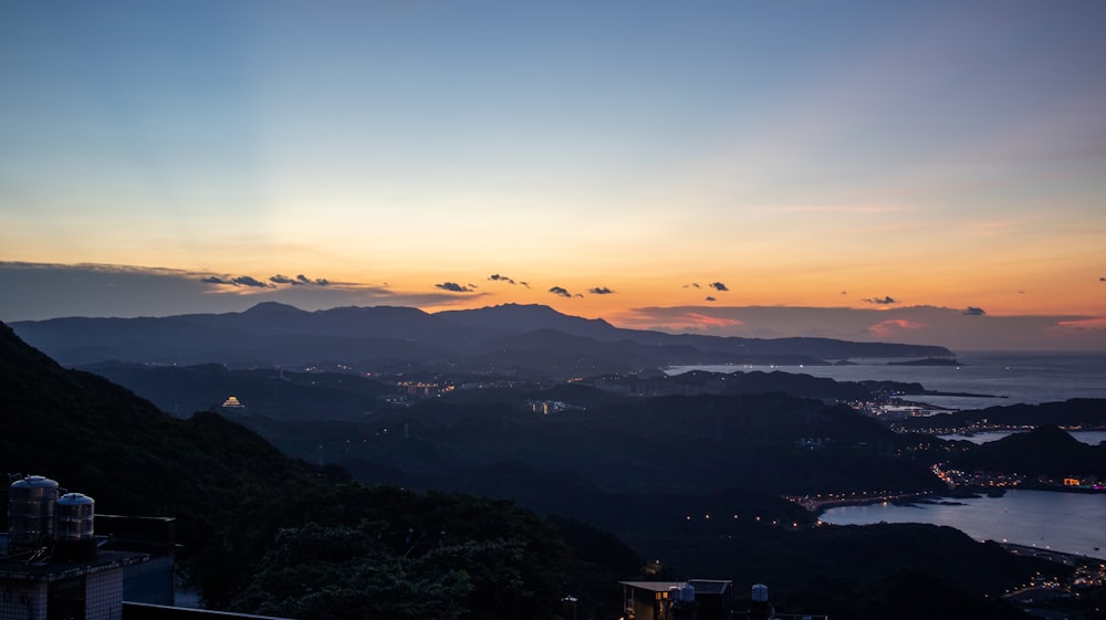 una vista del atardecer de una ciudad y un cuerpo de agua