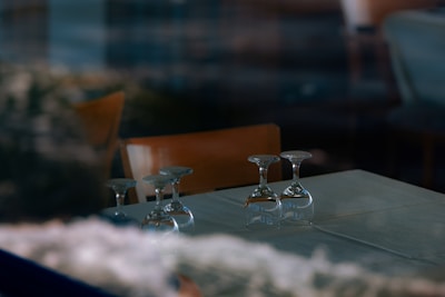 three wine glasses sitting on a table in a restaurant