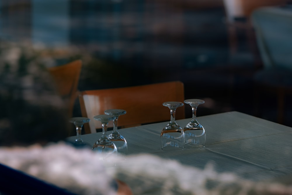 three wine glasses sitting on a table in a restaurant