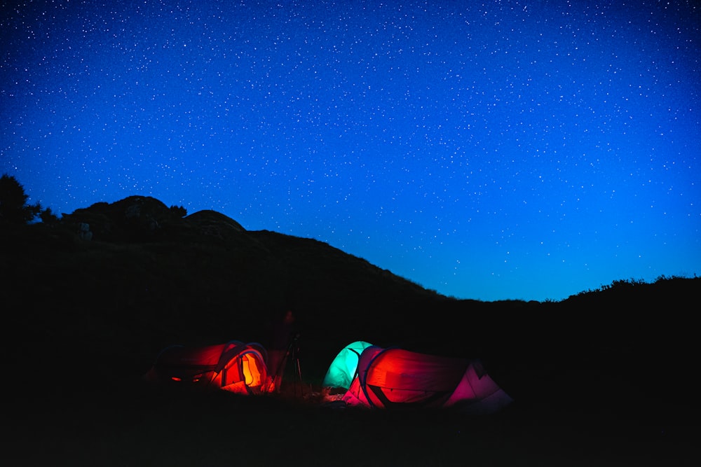 a couple of tents that are in the grass