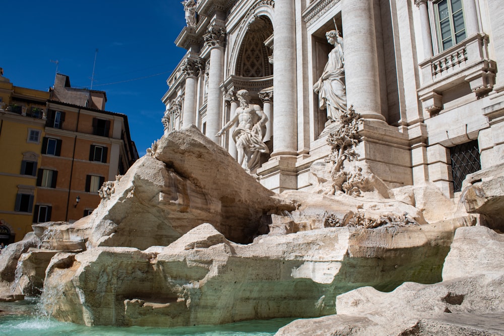 a large building with a fountain in front of it