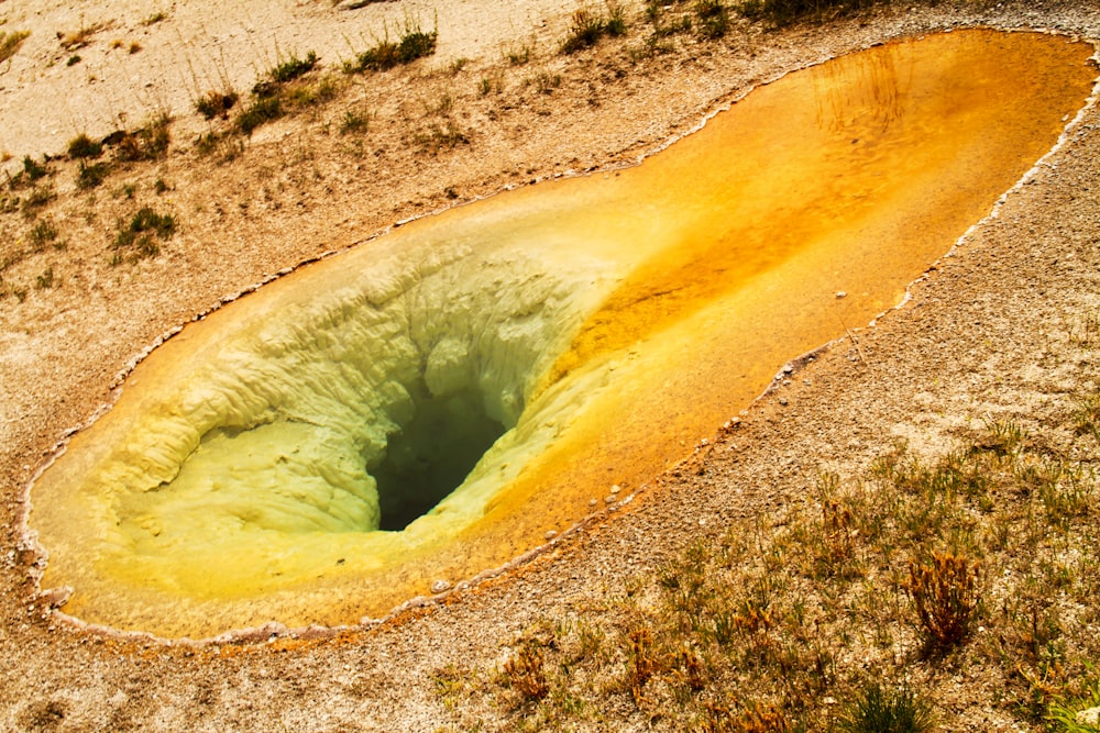 a large hole in the ground in the desert
