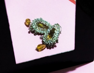 flat lay of modern cubic zirconia rhodium-plated earrings on cool ivory matte surface