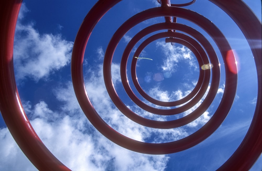 a metal sculpture with a sky in the background