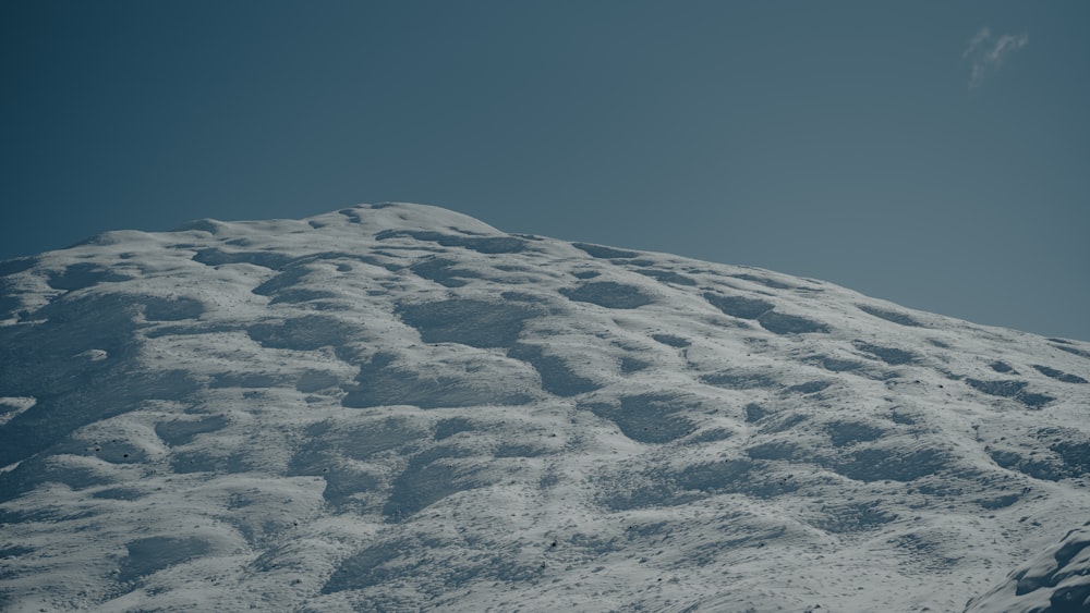 a snow covered mountain under a blue sky