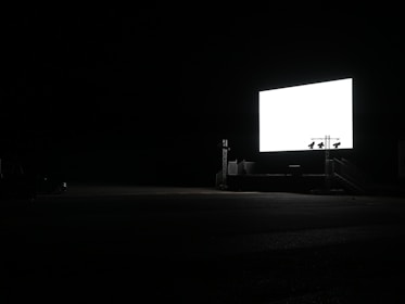 a dark room with a large screen in the middle of it