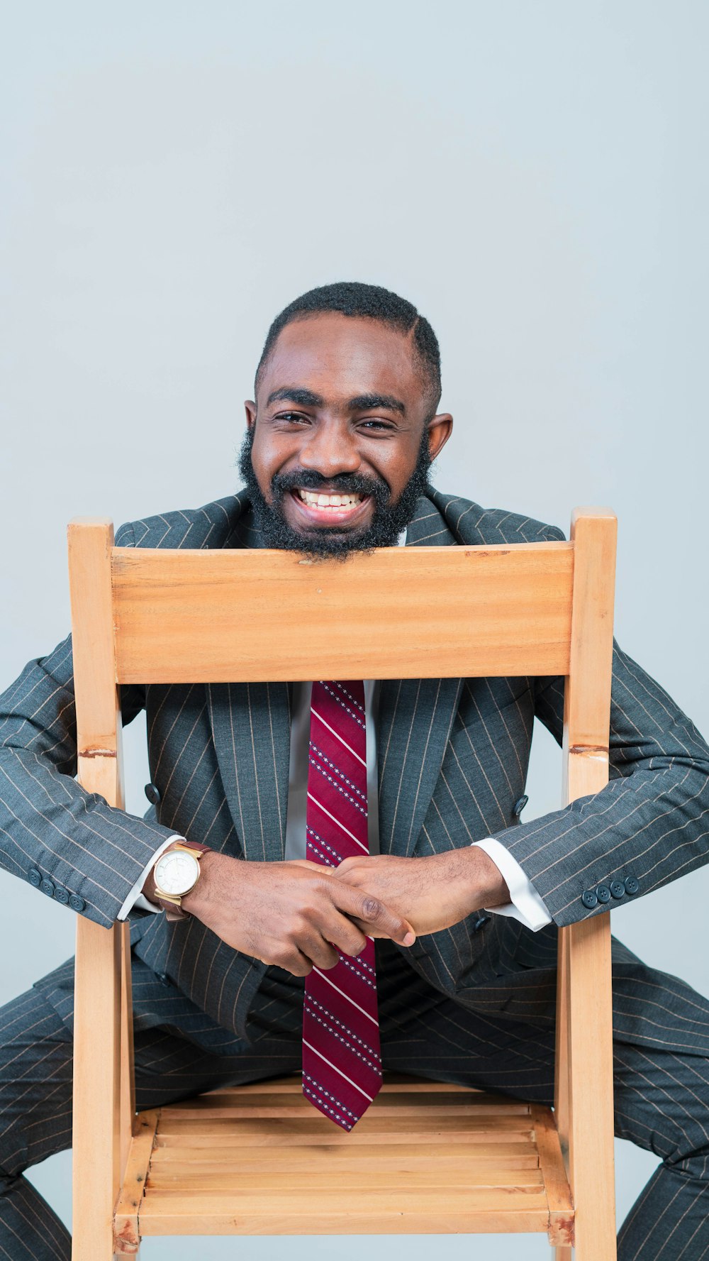 a man in a suit and tie sitting on a chair