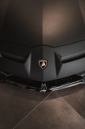 the front end of a black sports car