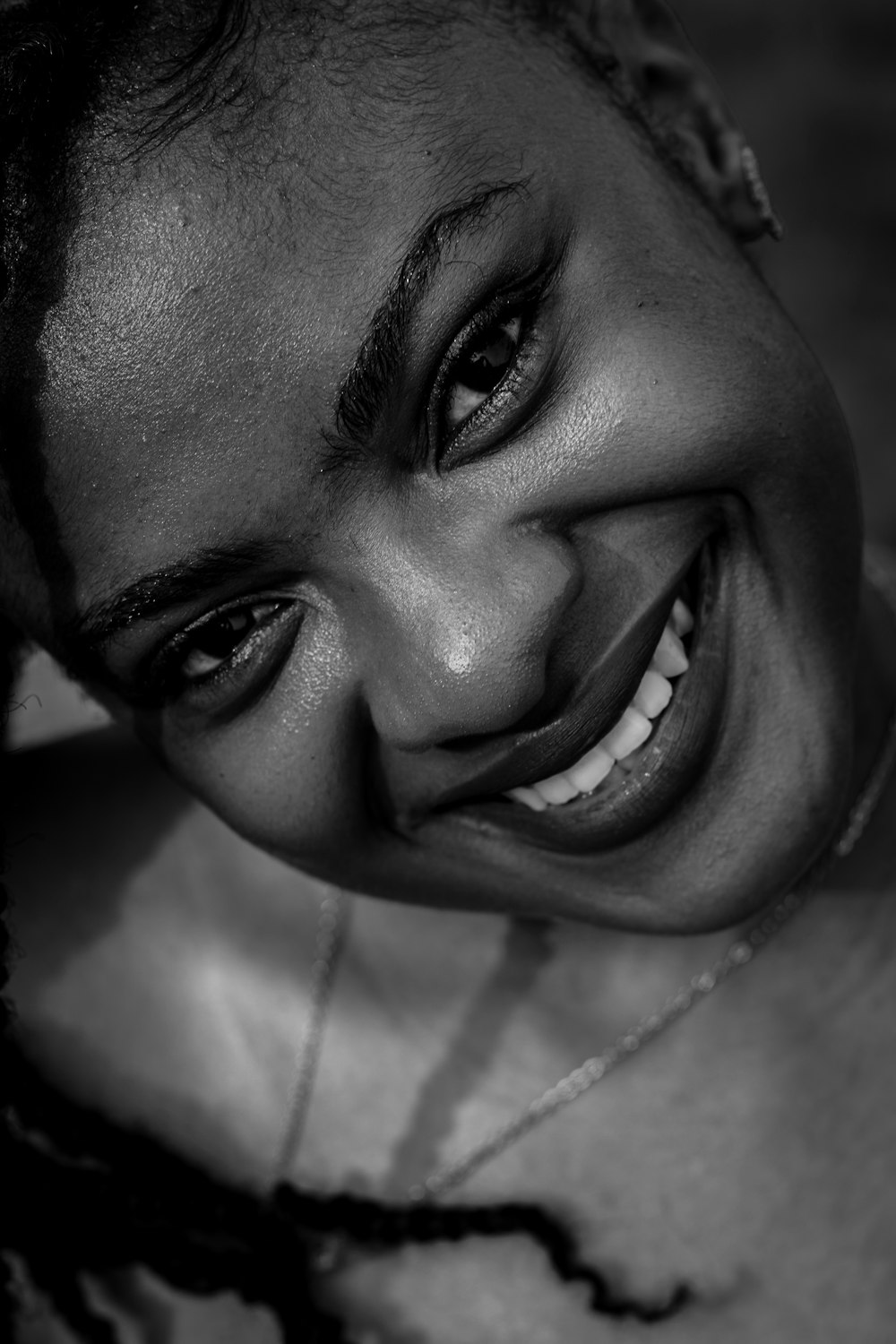 a black and white photo of a woman smiling