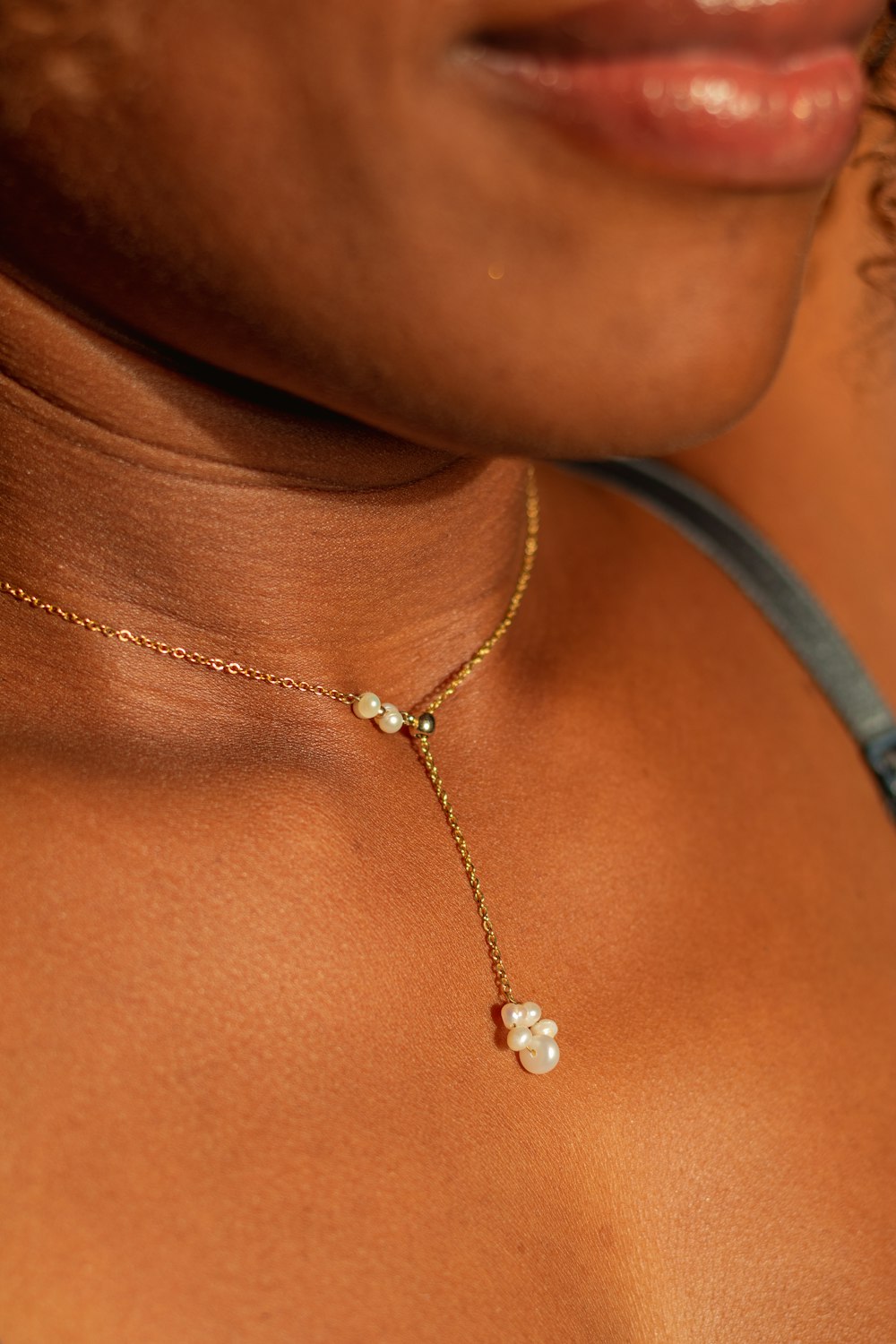 a close up of a person wearing a necklace