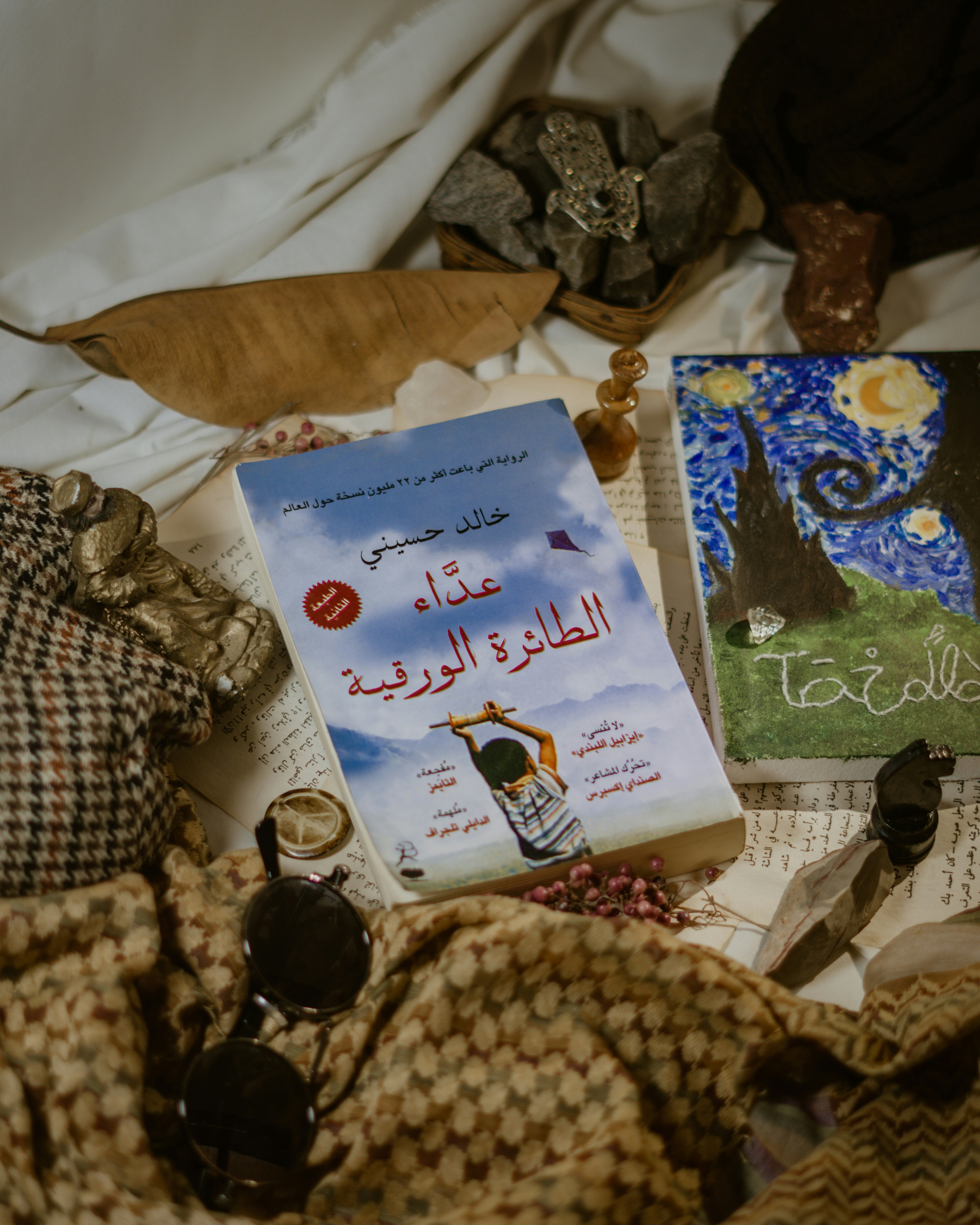 a pile of books sitting on top of a bed