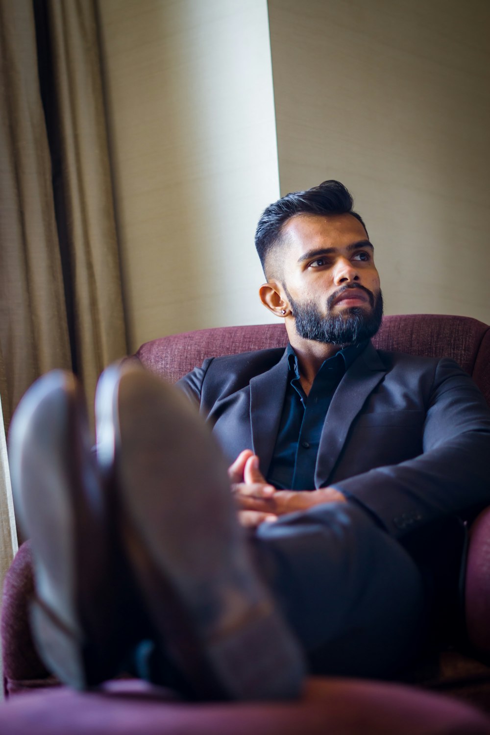 a man in a suit sitting in a chair