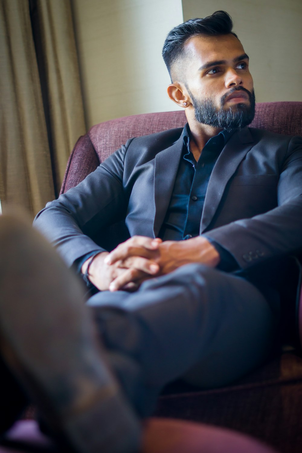 a man in a suit sitting in a chair