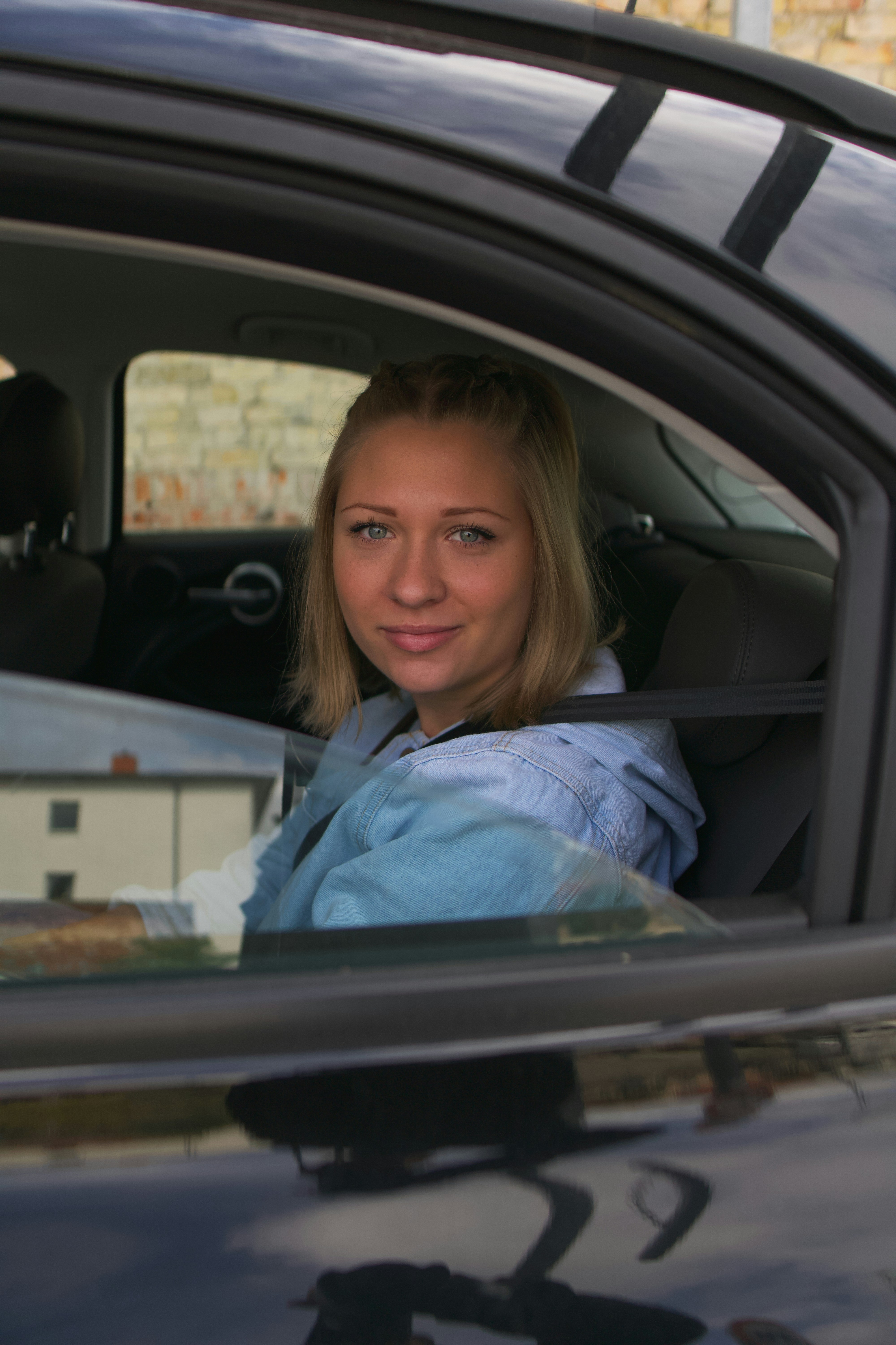a woman sitting in the passenger seat of a car