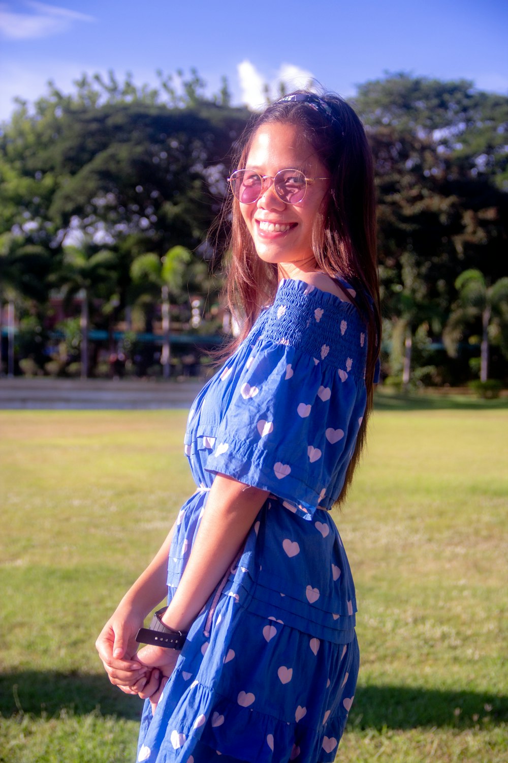 a woman in a blue dress posing for a picture