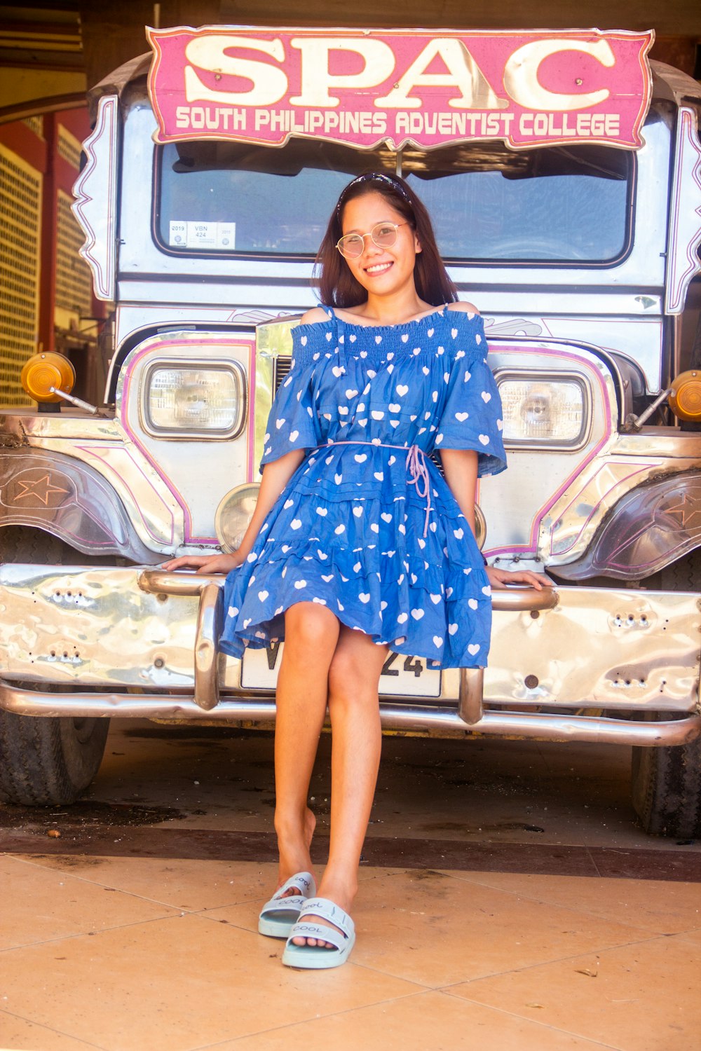 a woman sitting on the front of a truck