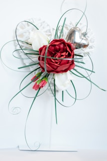 A cozy Valentine’s Day gift arrangement with scarlet mormon flower accents and soft pink ribbons.