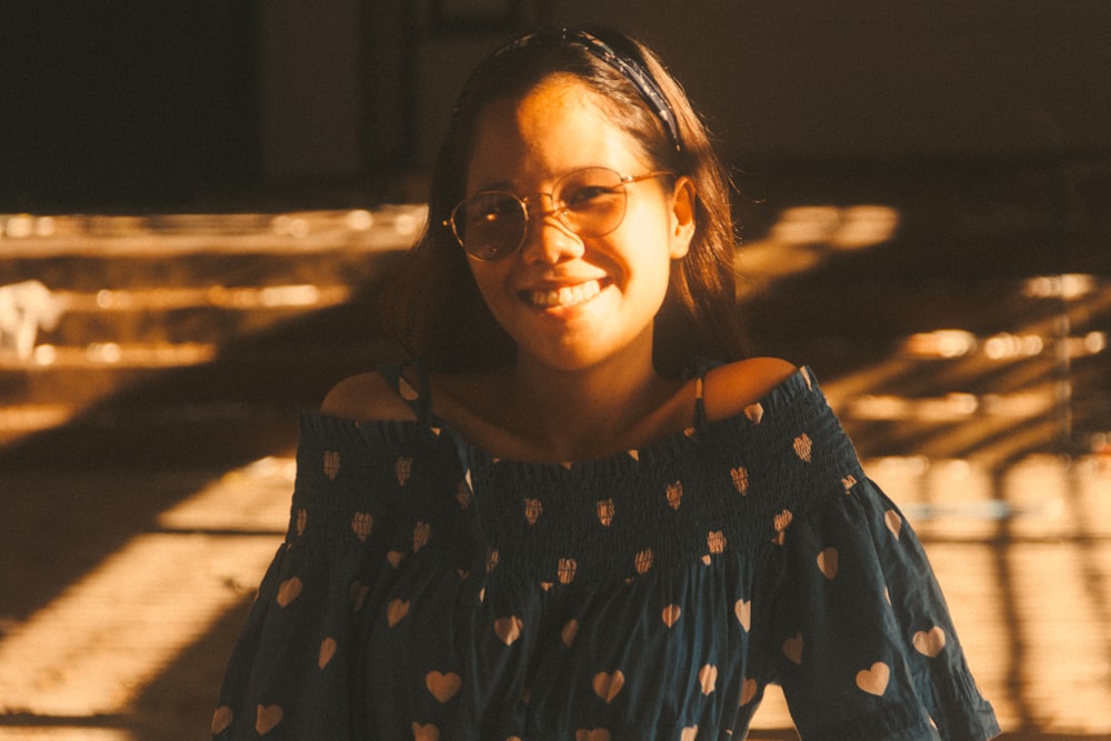 a young girl wearing glasses and a polka dot top