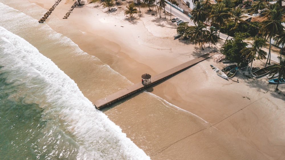 an aerial view of a beach with a pier