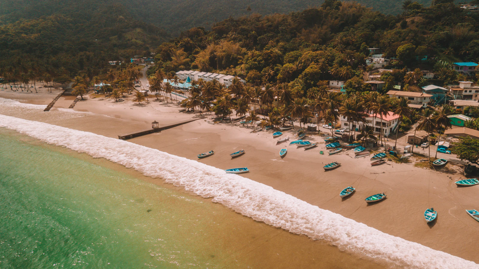 Aerial view of a Koh Phangan beach with longtail boats on turquoise water