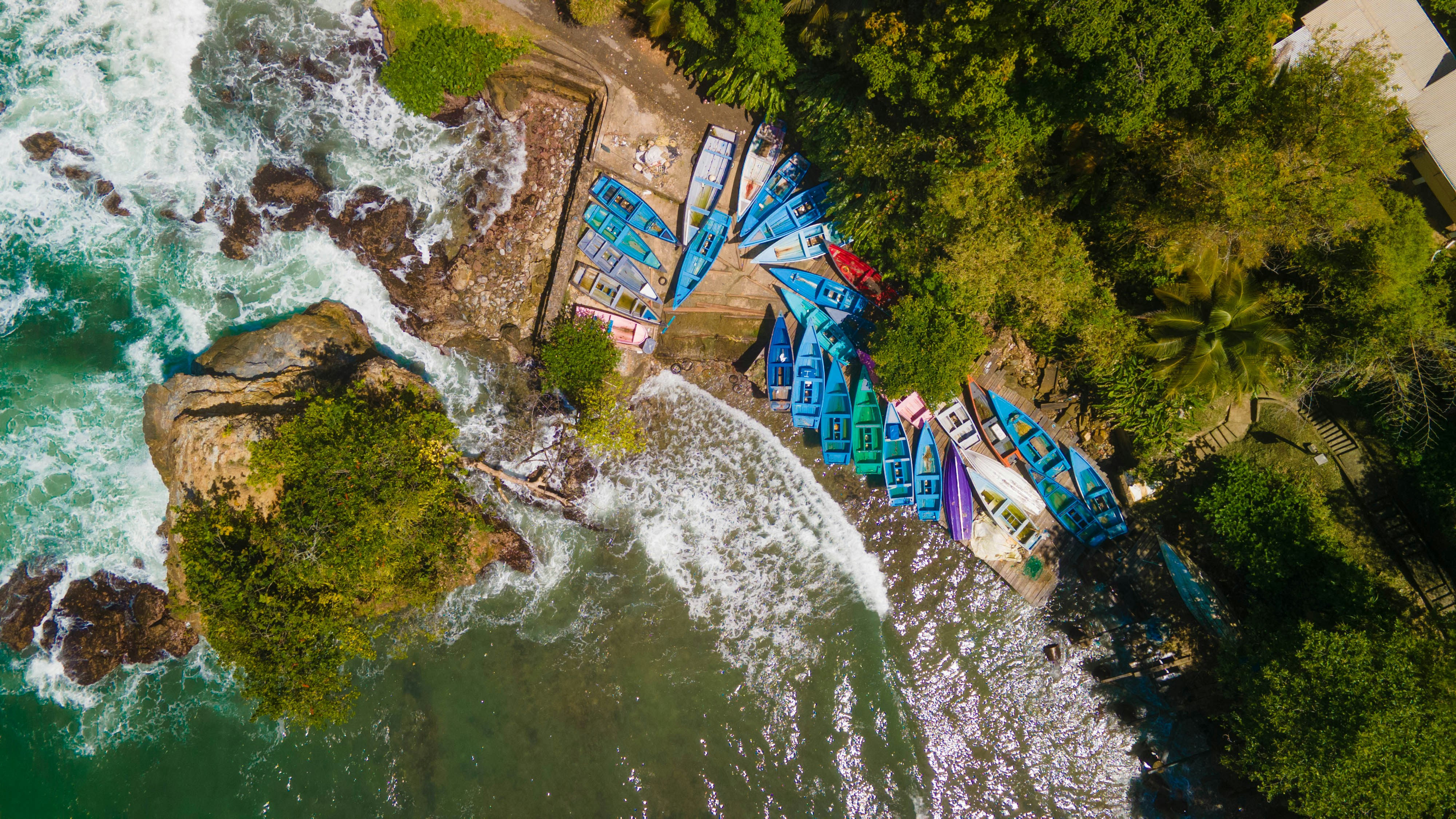 an aerial view of a beach with a bunch of boats