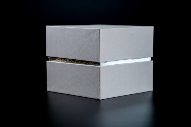 Close-up of a sleek metal distribution box with precise edges and a brushed finish.