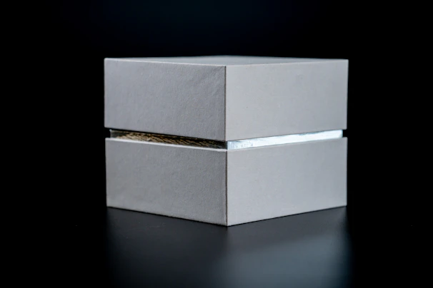 A sleek modern music box with minimalist design and a smooth metallic surface.