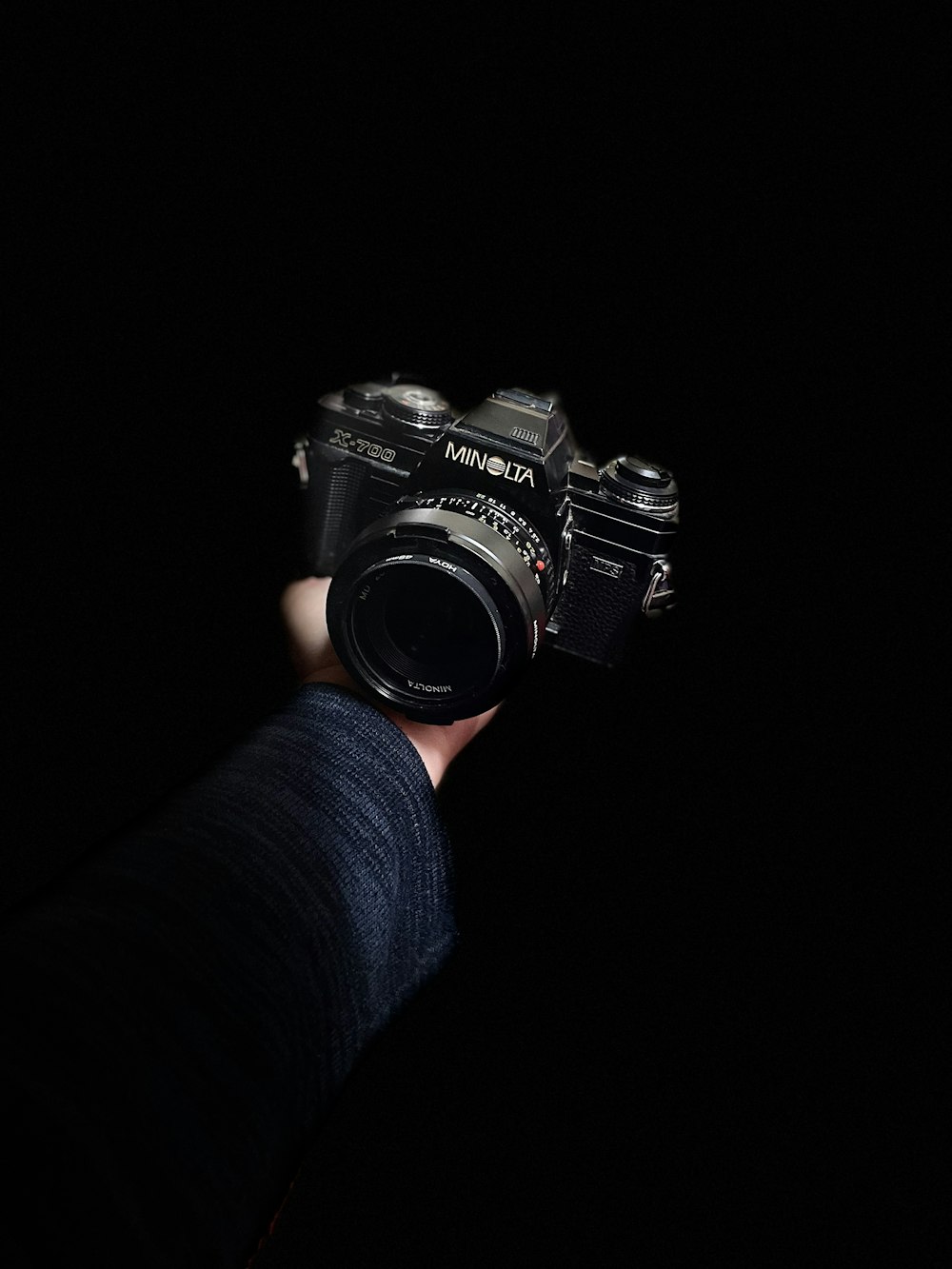 a person holding a camera in the dark