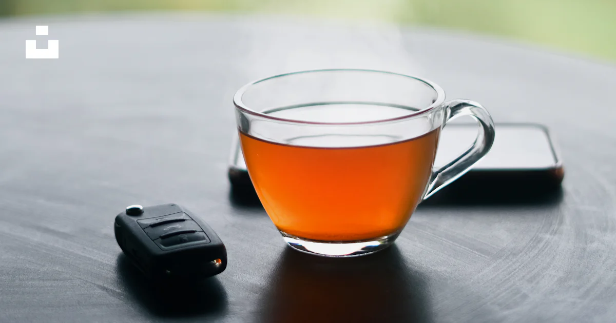 A cup of tea and a cell phone on a table photo – Free Tea Image on Unsplash