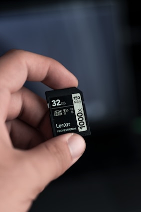 a hand holding a micro sd memory card