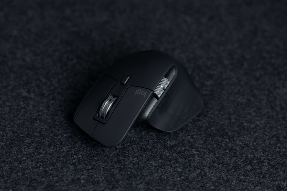 a close up of a mouse on a black surface
