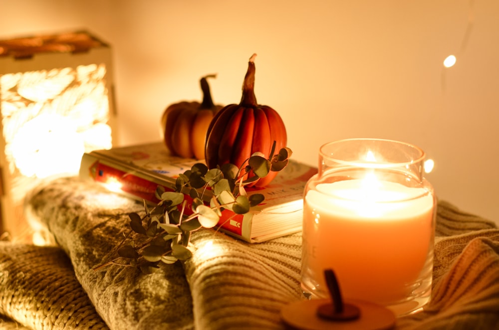 a candle and some books on a couch