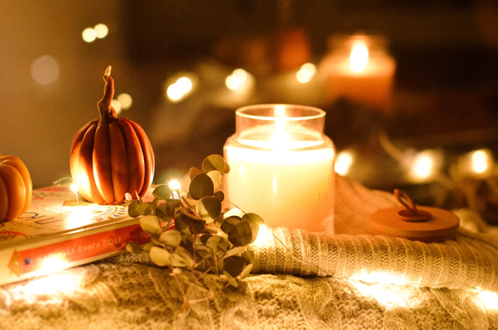 a candle and some books on a table