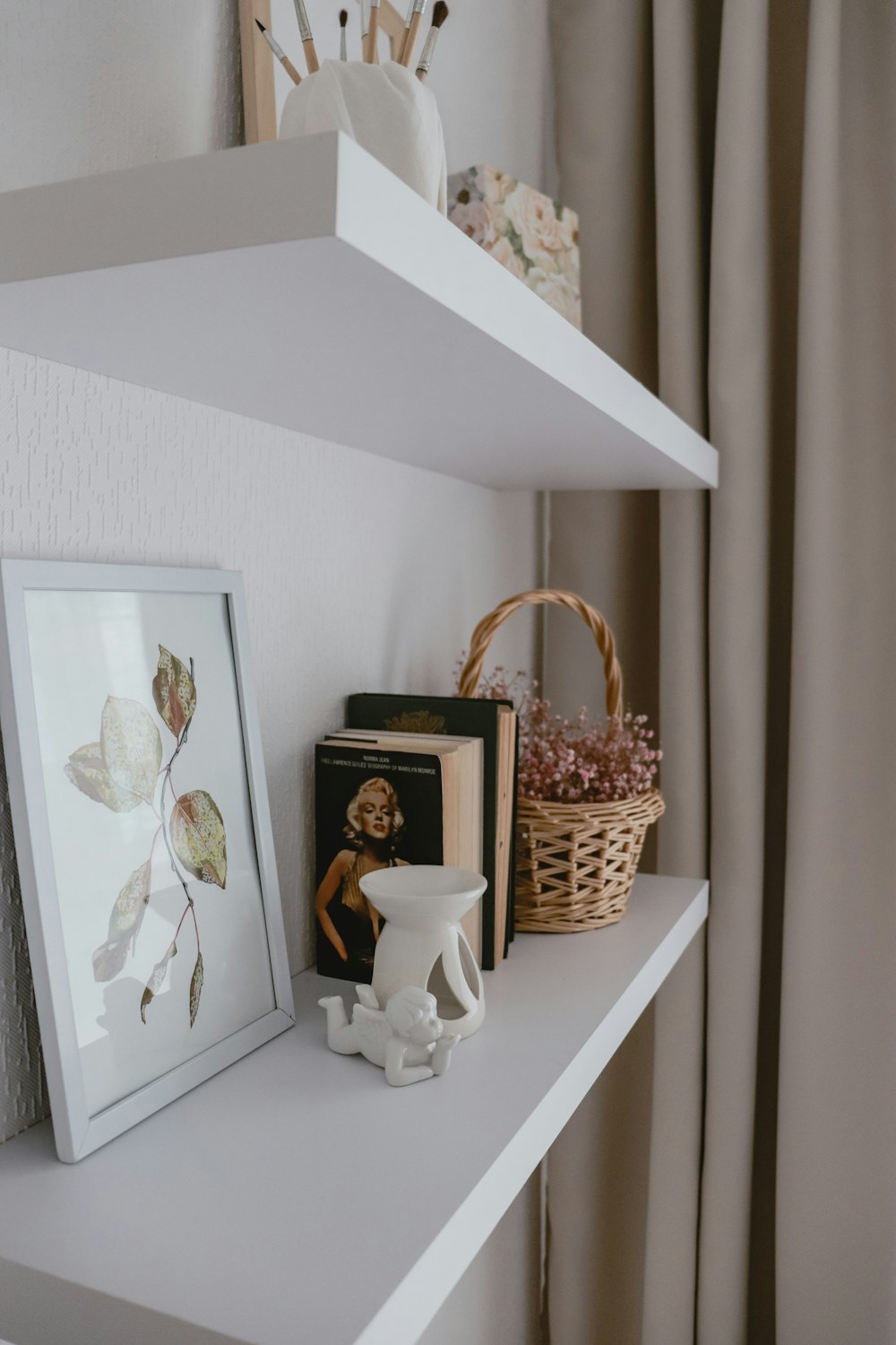 a shelf with a basket and a picture on it