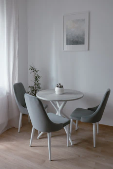 A minimalist dining table set with elegant chairs in a cozy dining area.