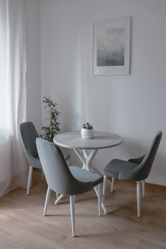 A compact dining area with a simple table and elegant chairs.