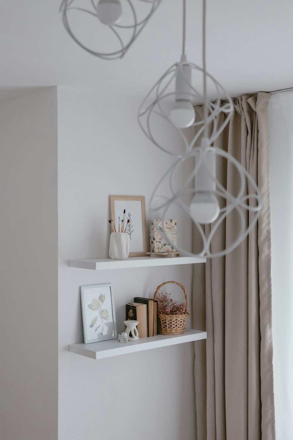 a white shelf with books and pictures on it