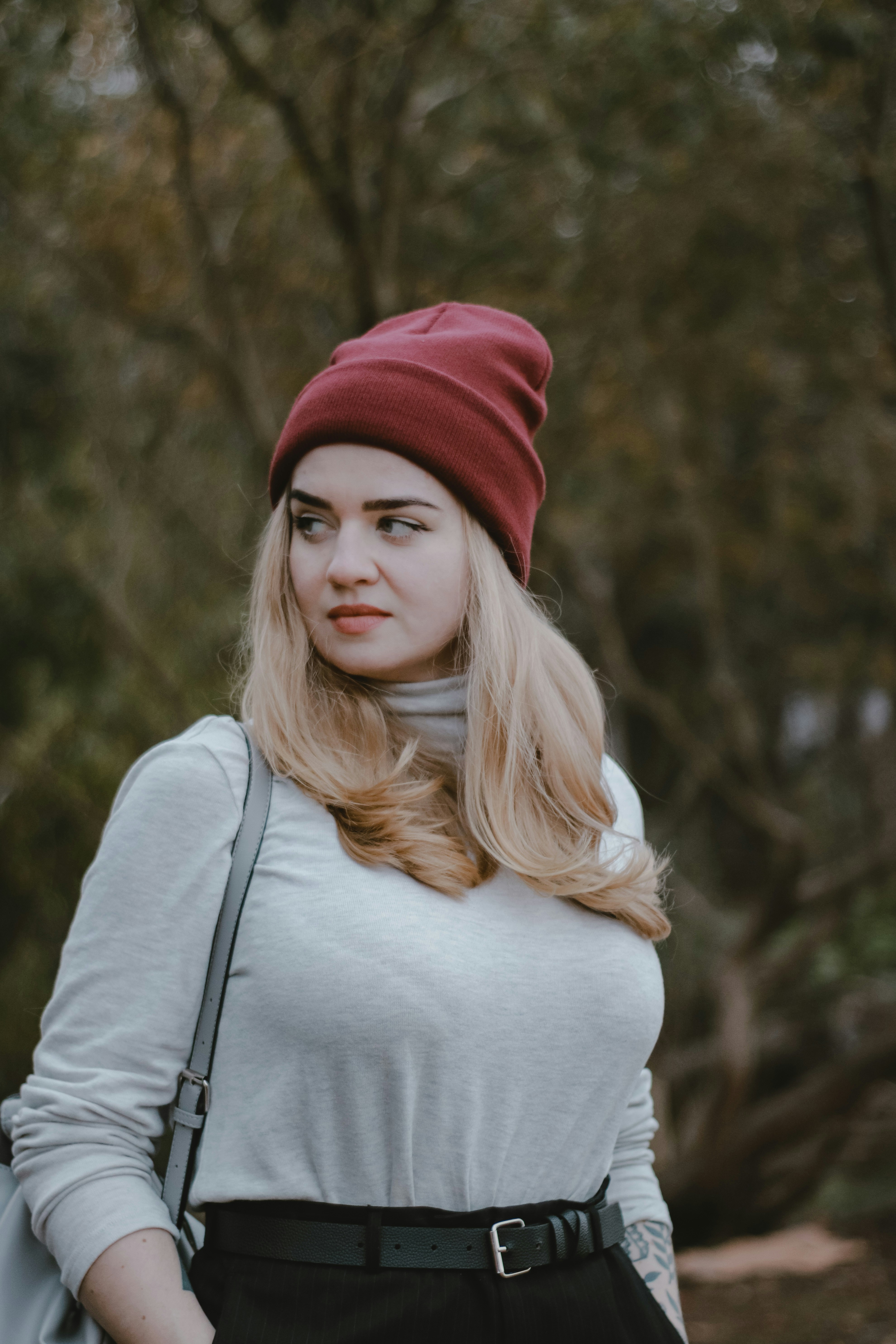 a woman with blonde hair wearing a red beanie